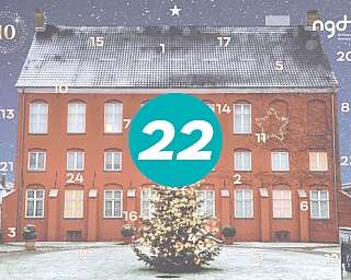 Ein rotes Haus mit Weihnachtsbaum und Schneefall.